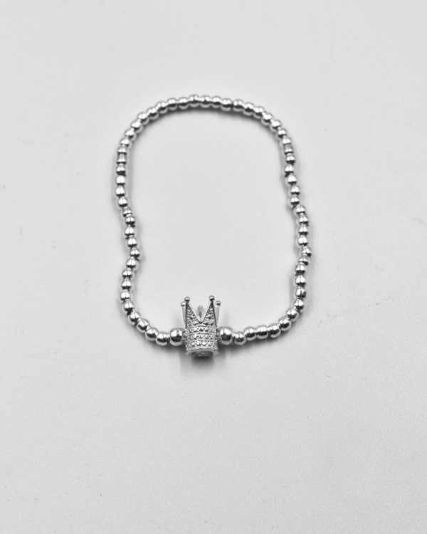 Pulsera elastica de bolitas de plata con una corona picos